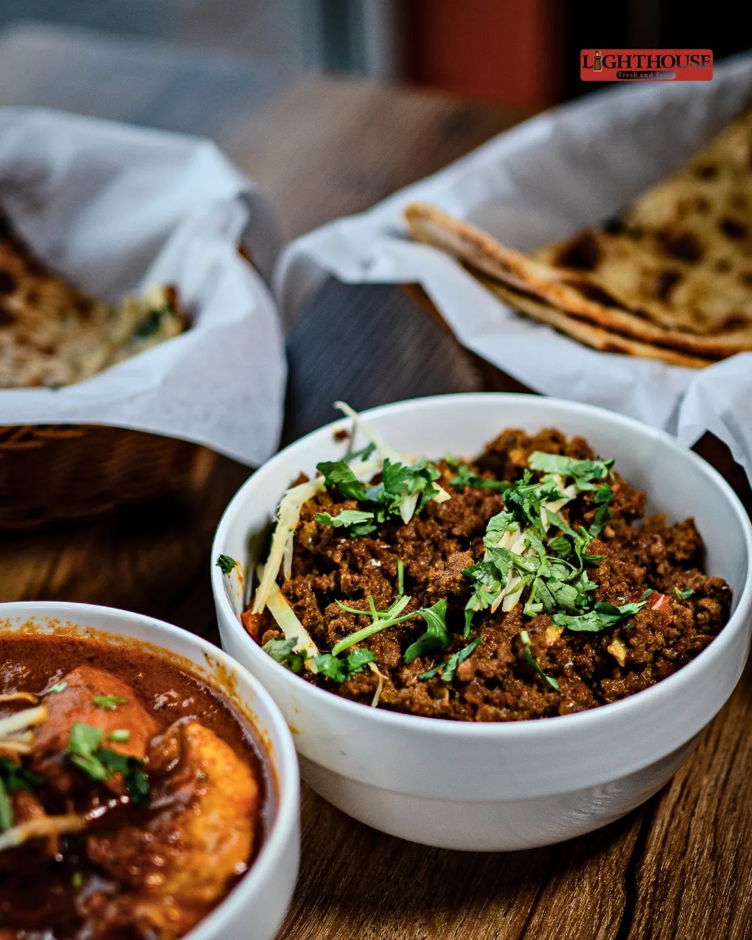 A generous table of Indian dishes and warm breads